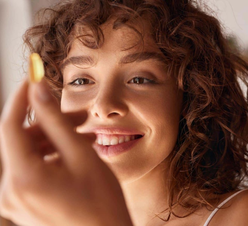 Woman looking at a probiotic patented pill