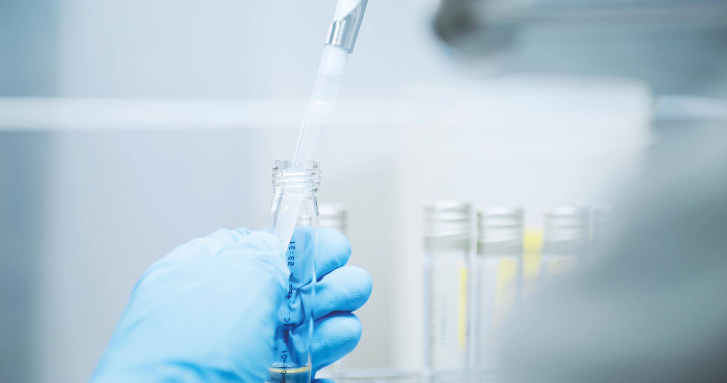 Scientist holding a glass test tube