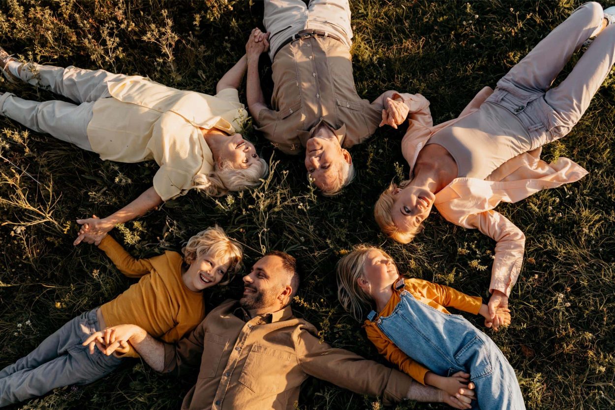 A whole family lying on the grass with good immune health