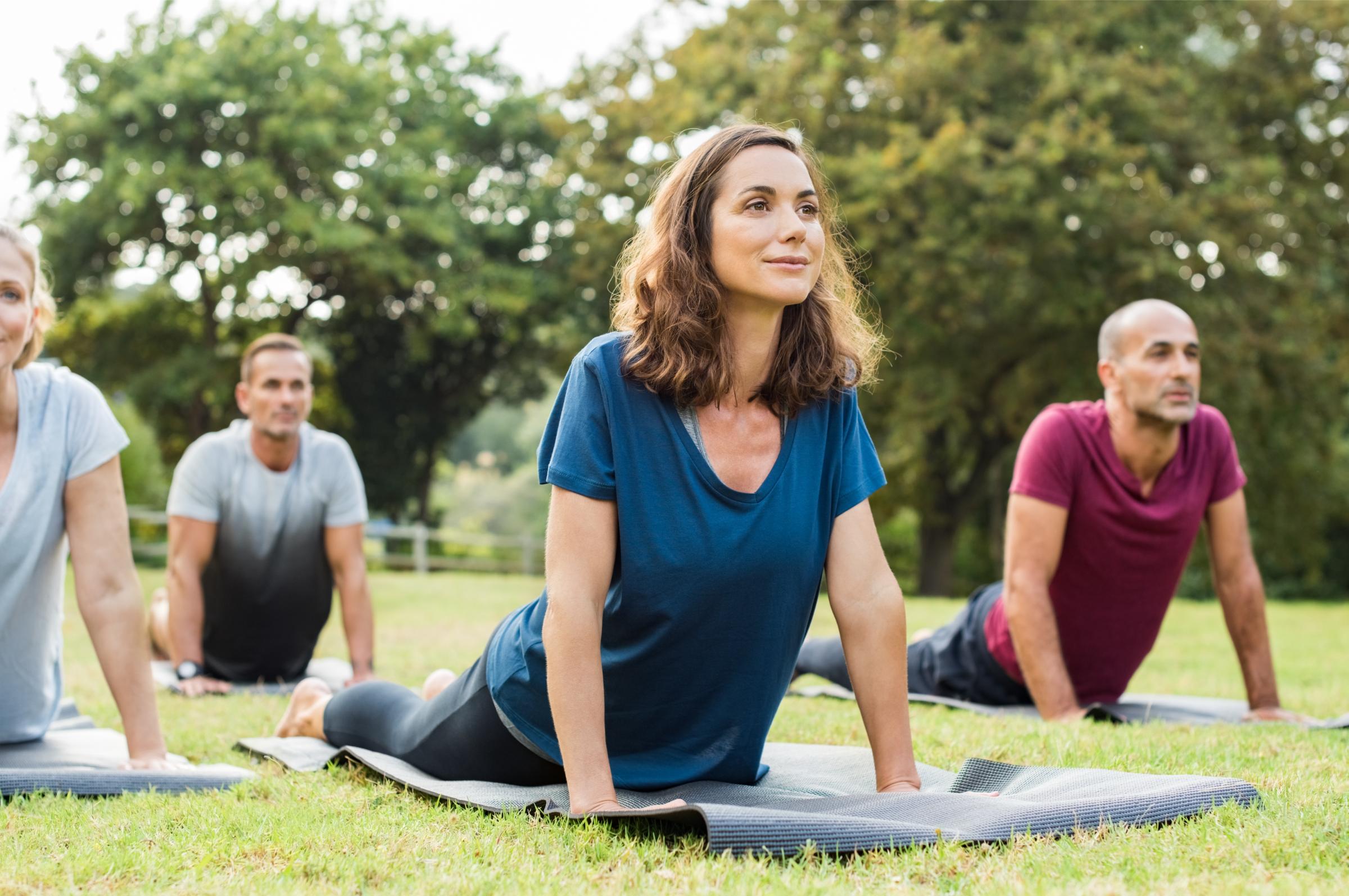 Group of people being healthy and happy while doing yoga